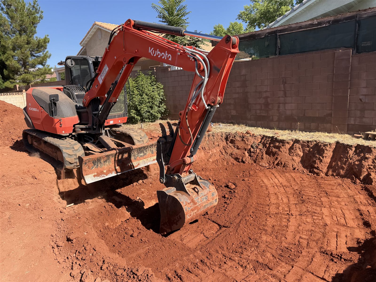 Excavator preparing a building pad